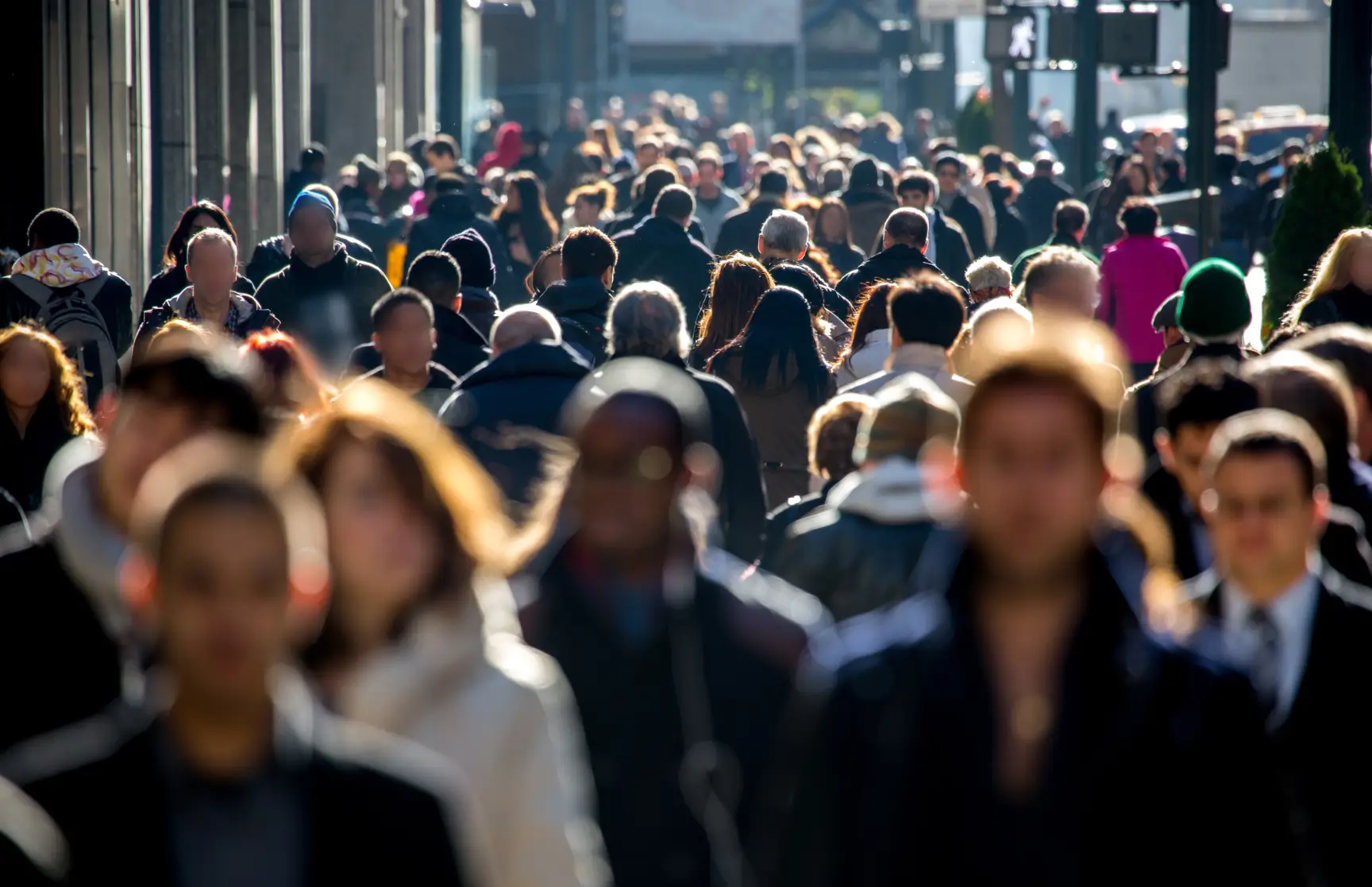 Large group of pedestrians walking in a city